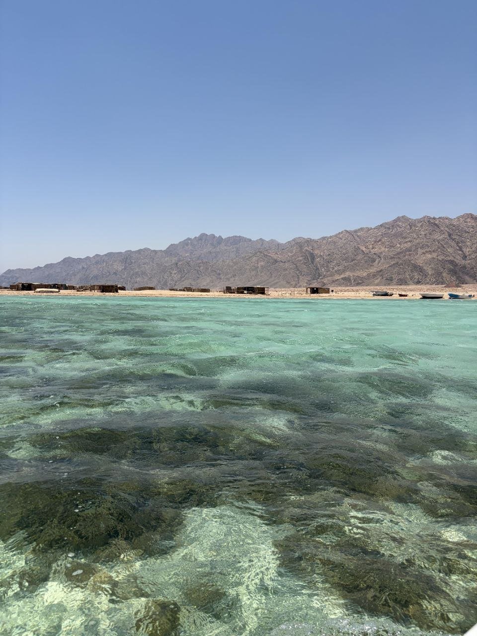 Clear reef water with the Sinai mountains behind